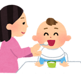 イラスト：子供に離乳食を食べさせる母親