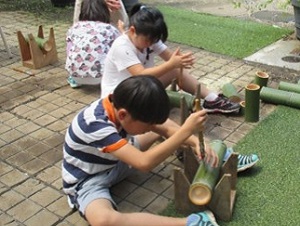 竹の工作をする子供達の写真